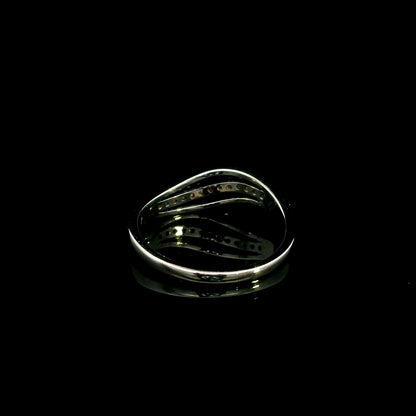 18K white gold diamond wave ring with a curved row of round diamonds and flowing polished gold design