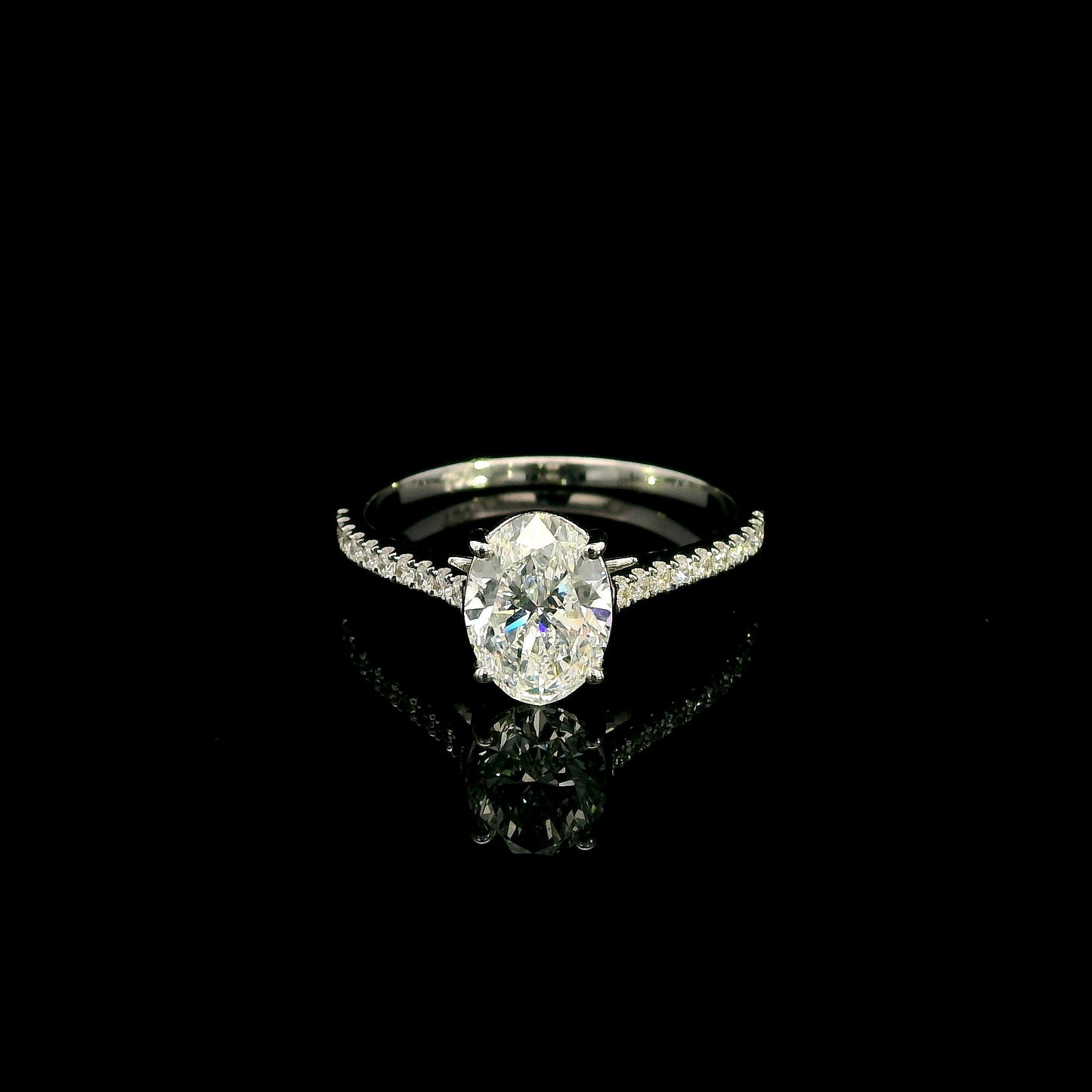 Oval cut diamond bridal set in 18K white gold featuring a GIA certified 1.50 carat natural oval diamond with matching diamond wedding band.