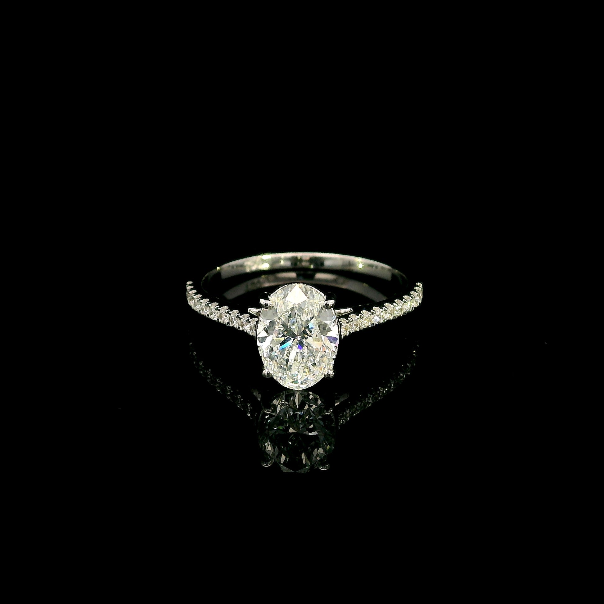Oval cut diamond bridal set in 18K white gold featuring a GIA certified 1.50 carat natural oval diamond with matching diamond wedding band.