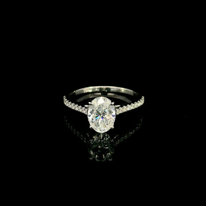 Oval cut diamond bridal set in 18K white gold featuring a GIA certified 1.50 carat natural oval diamond with matching diamond wedding band.