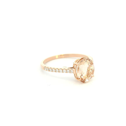 Oval morganite diamond ring handcrafted in 18K rose gold featuring a 1.84 carat natural oval morganite with 0.16 carat natural diamond pavé band.