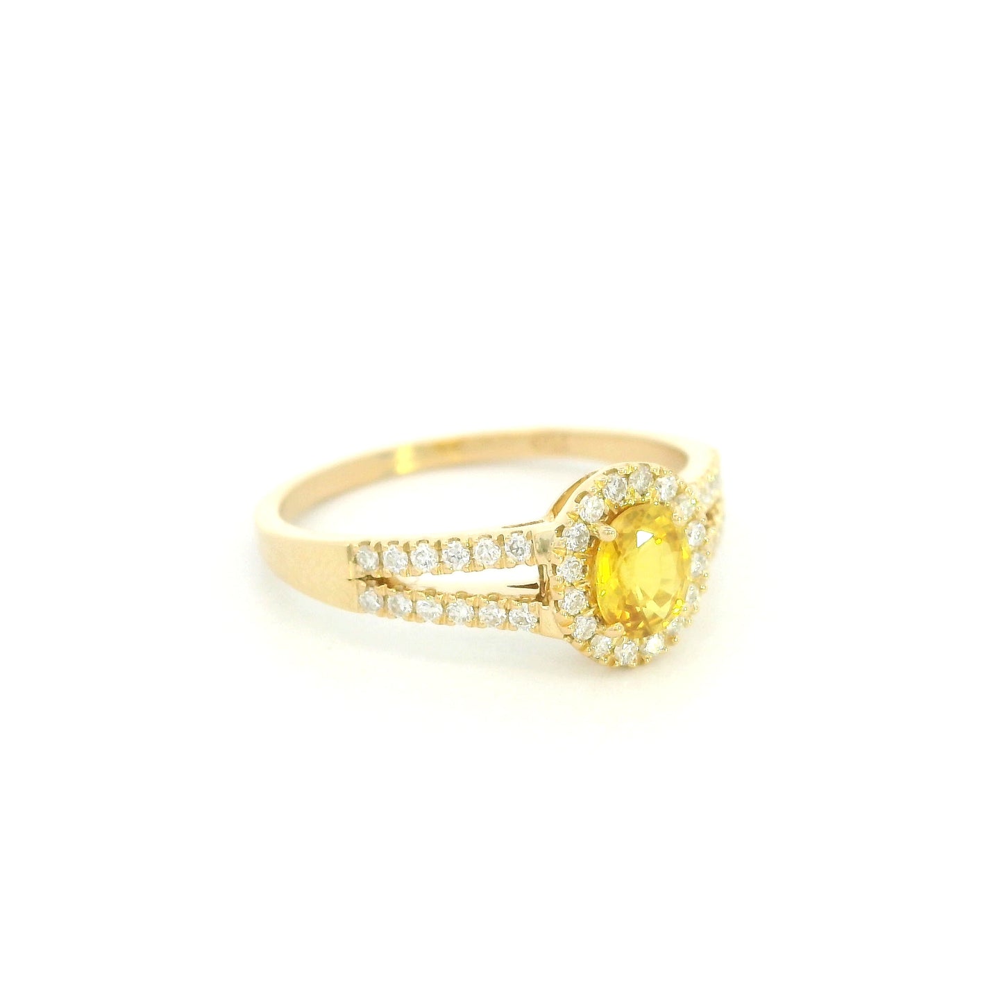 Natural yellow sapphire halo ring in 18K yellow gold featuring a 0.58 carat oval yellow sapphire with a split shank and 0.26 carat natural diamonds.