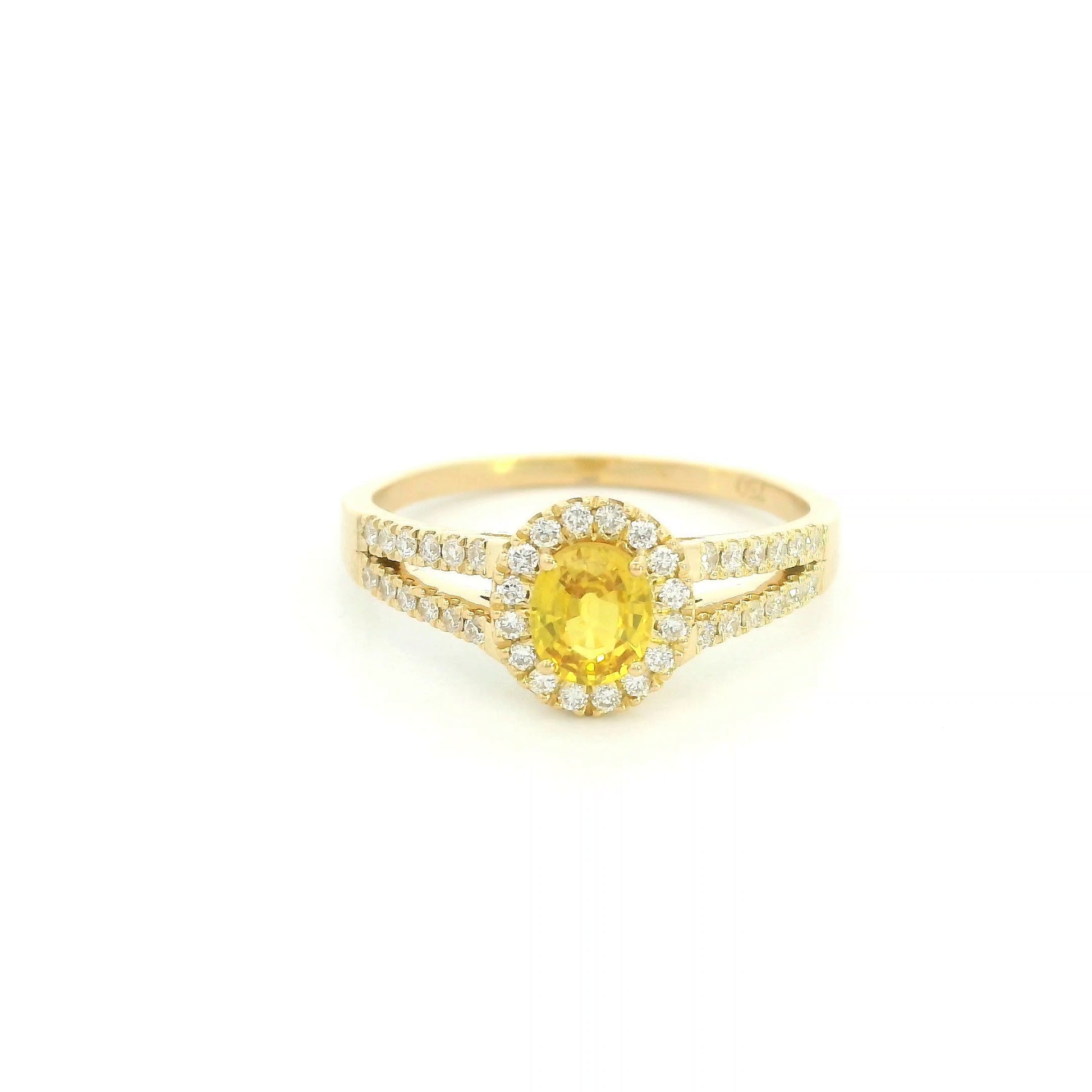 Natural yellow sapphire halo ring in 18K yellow gold featuring a 0.58 carat oval yellow sapphire with a split shank and 0.26 carat natural diamonds.