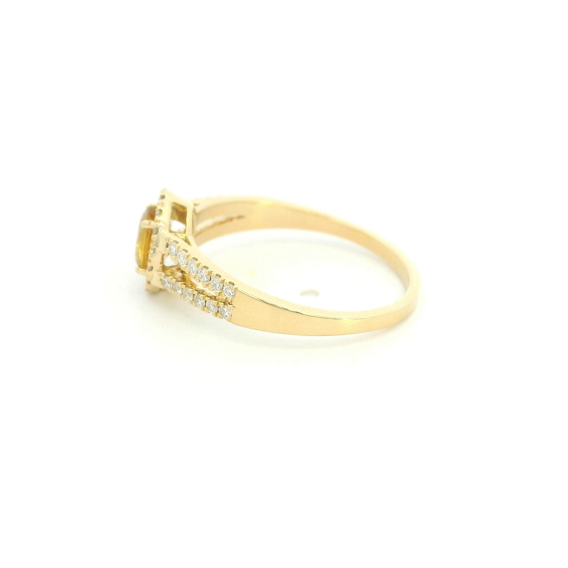 Natural yellow sapphire halo ring in 18K yellow gold featuring a 0.58 carat oval yellow sapphire with a split shank and 0.26 carat natural diamonds.