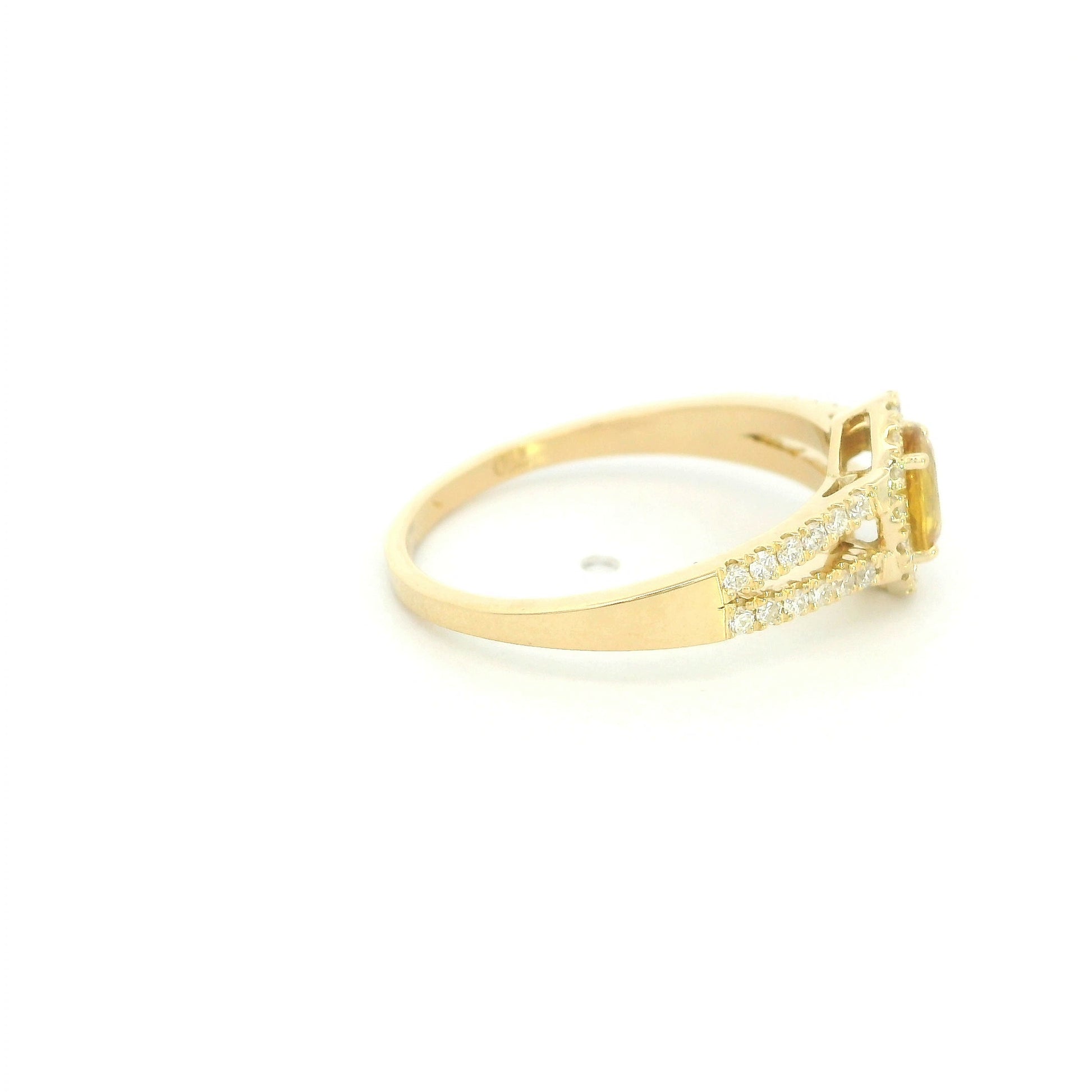 Natural yellow sapphire halo ring in 18K yellow gold featuring a 0.58 carat oval yellow sapphire with a split shank and 0.26 carat natural diamonds.