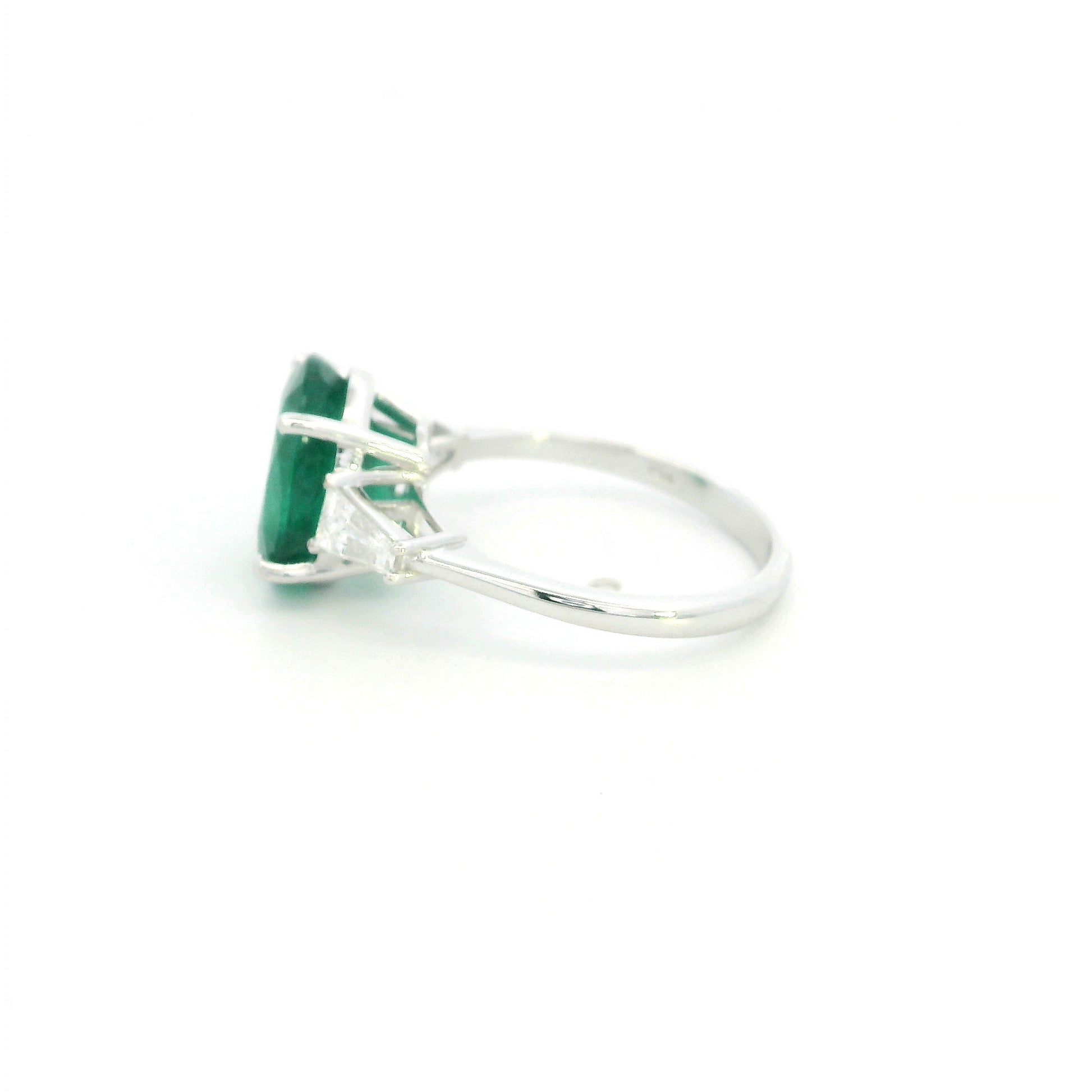 Natural oval emerald and tapered baguette diamond three stone ring in 18K white gold with a 4.03 carat centre emerald.