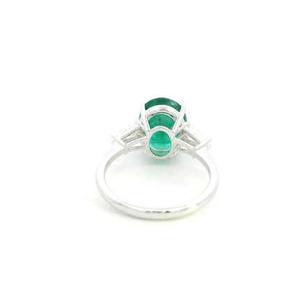 Natural oval emerald and tapered baguette diamond three stone ring in 18K white gold with a 4.03 carat centre emerald.