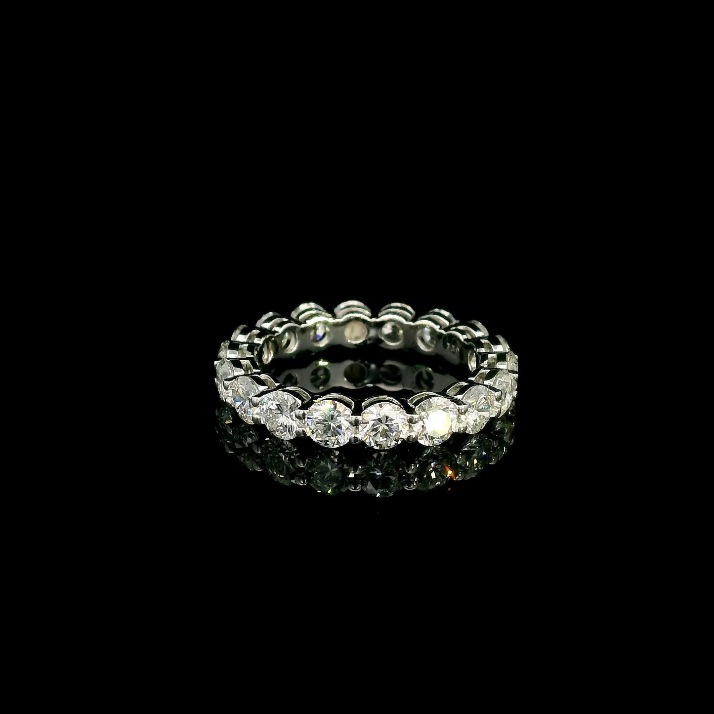 Full diamond eternity ring with round brilliant diamonds set around the entire band in 18K white gold.