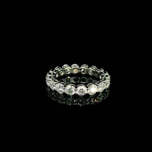 Full diamond eternity ring with round brilliant diamonds set around the entire band in 18K white gold.
