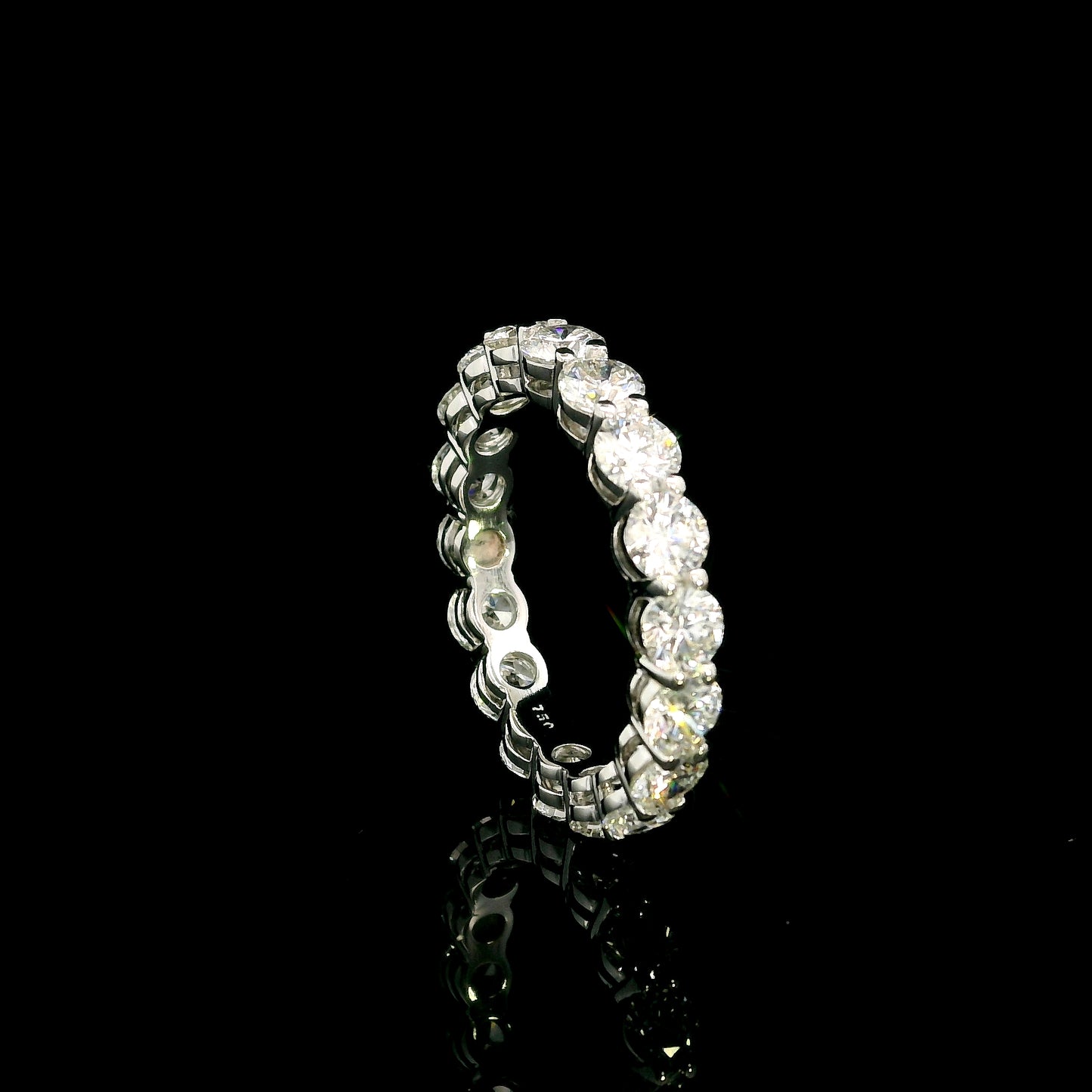 Full diamond eternity ring with round brilliant diamonds set around the entire band in 18K white gold.