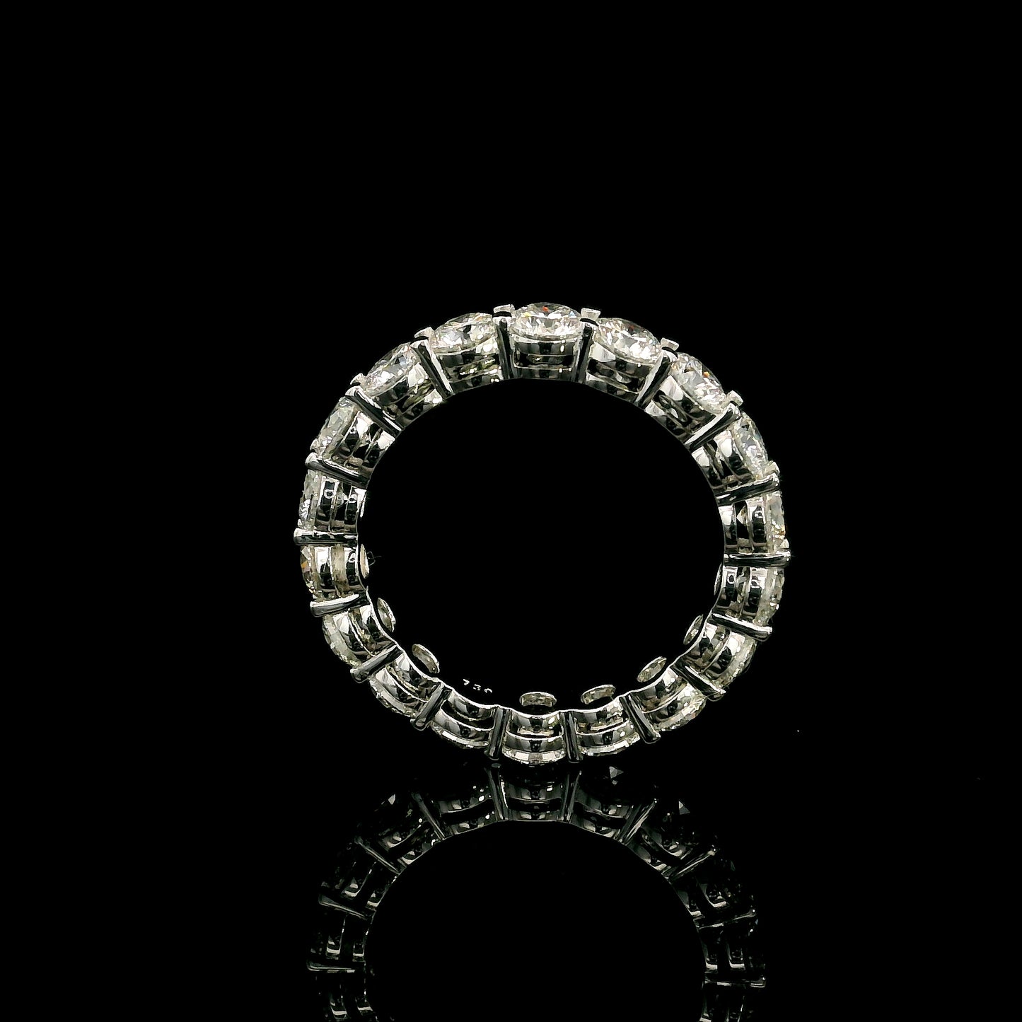 Full diamond eternity ring with round brilliant diamonds set around the entire band in 18K white gold.