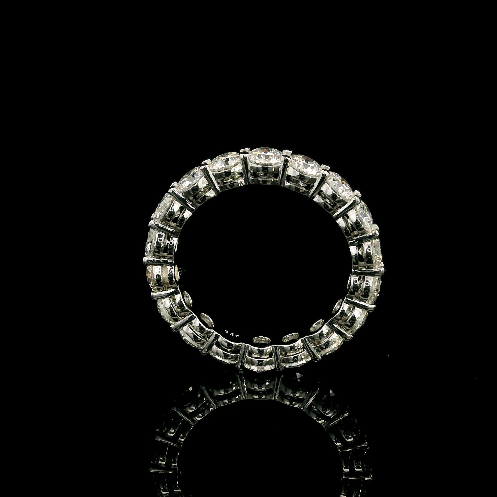 Full diamond eternity ring with round brilliant diamonds set around the entire band in 18K white gold.