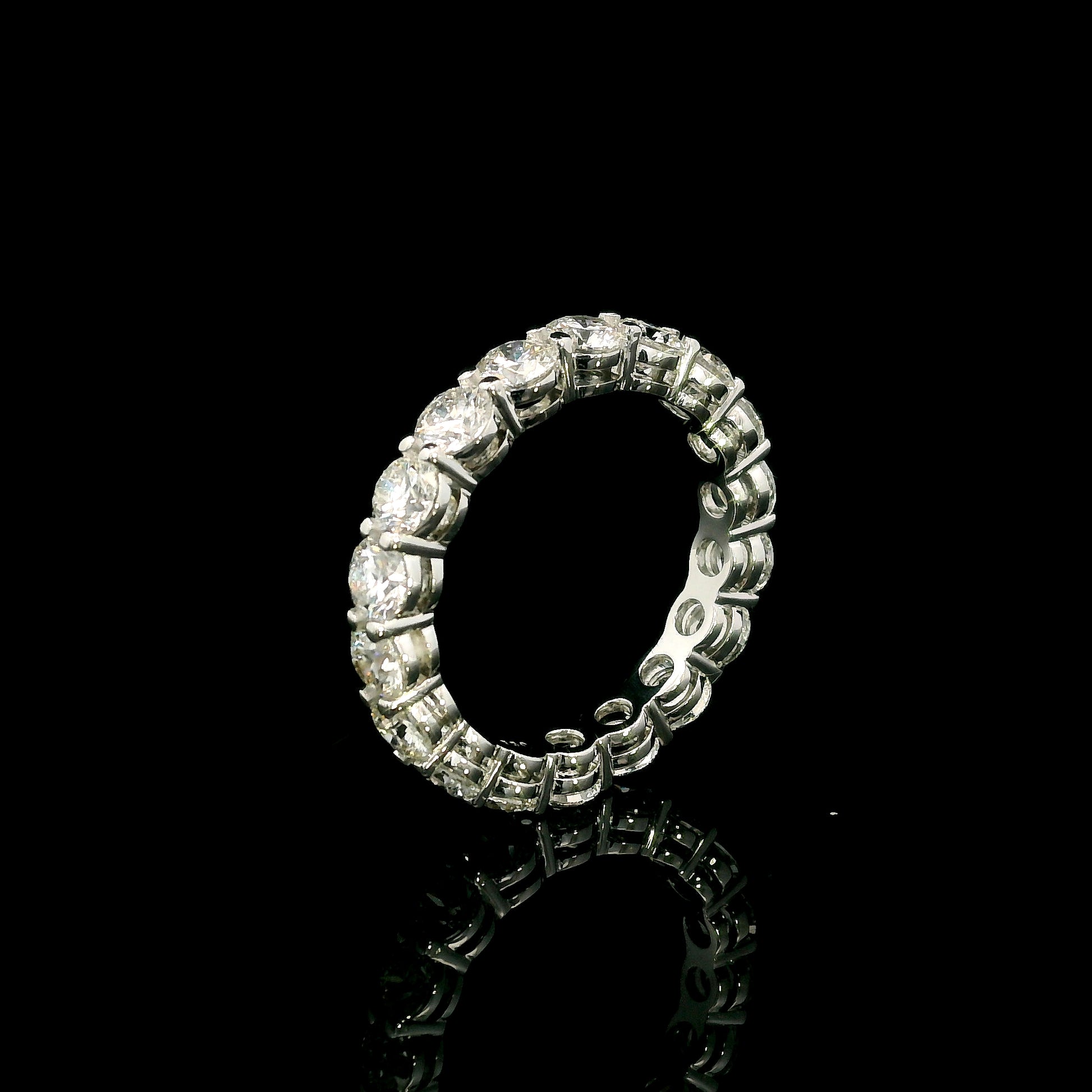 Full diamond eternity ring with round brilliant diamonds set around the entire band in 18K white gold.