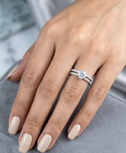 Round diamond bridal set in 18K white gold with GIA certified natural diamond engagement ring and matching diamond wedding band.
