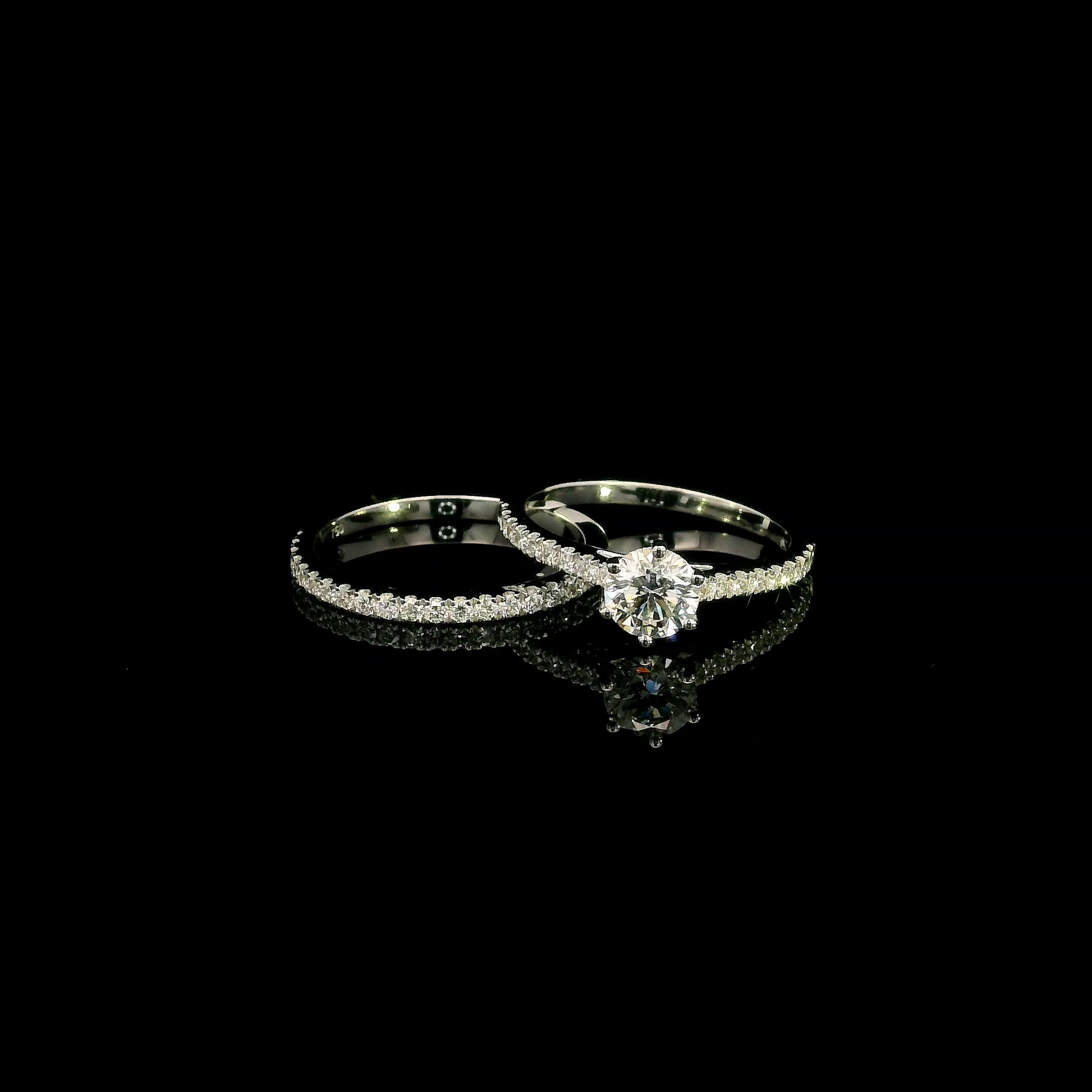 Round diamond bridal set in 18K white gold with GIA certified natural diamond engagement ring and matching diamond wedding band.
