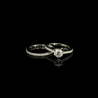 Round diamond bridal set in 18K white gold with GIA certified natural diamond engagement ring and matching diamond wedding band.