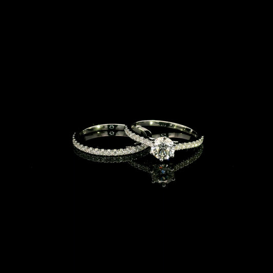 Round diamond bridal set in 18K white gold with GIA certified natural diamond engagement ring and matching diamond wedding band.