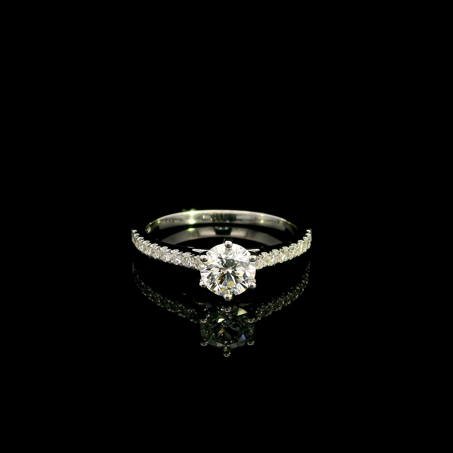 Round diamond bridal set in 18K white gold with GIA certified natural diamond engagement ring and matching diamond wedding band.