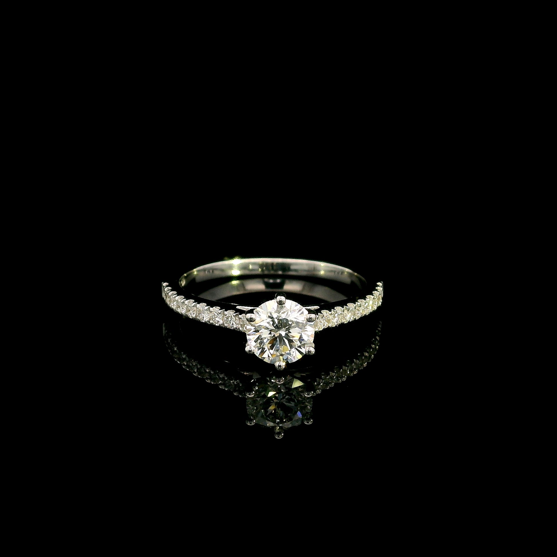 Round diamond bridal set in 18K white gold with GIA certified natural diamond engagement ring and matching diamond wedding band.