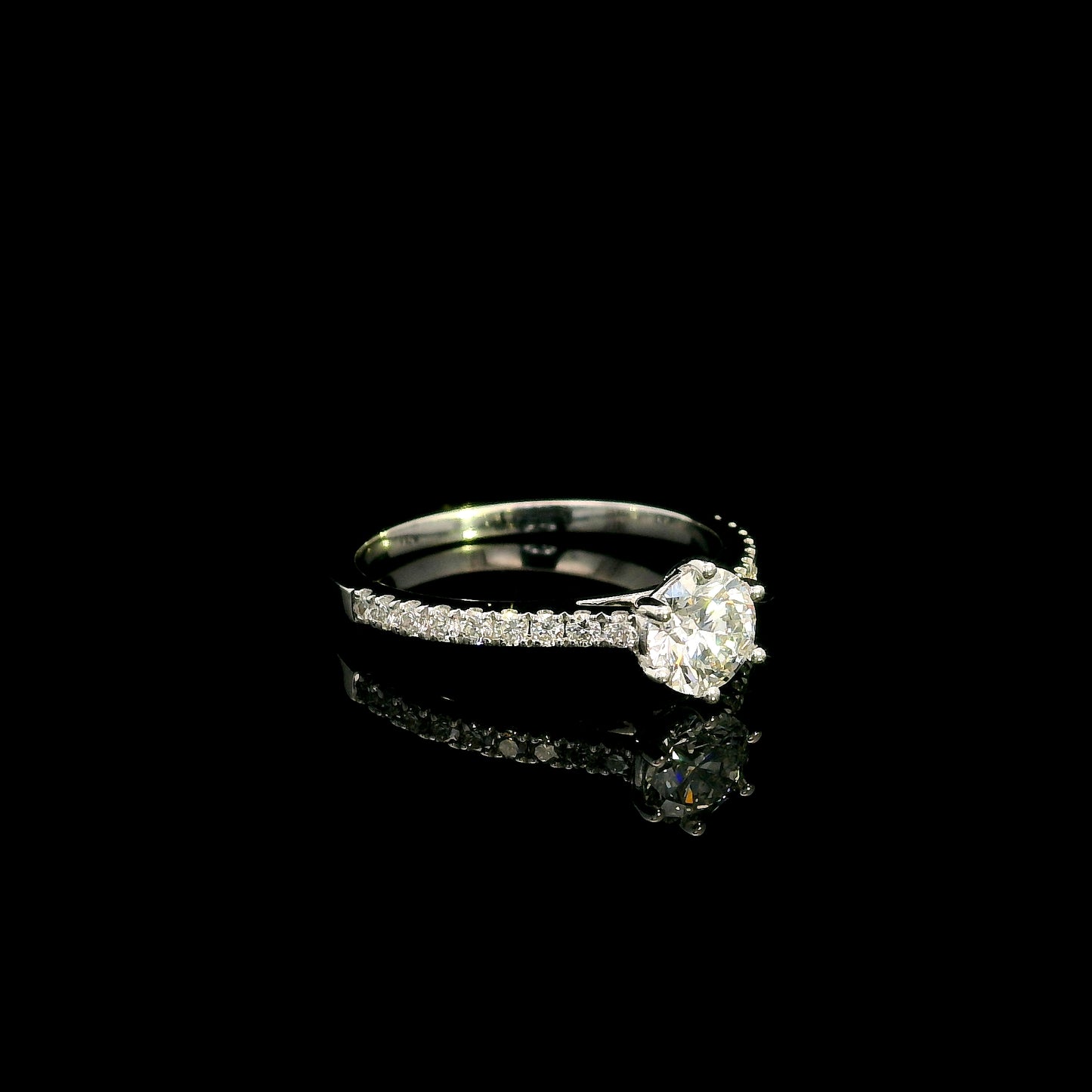 Round diamond bridal set in 18K white gold with GIA certified natural diamond engagement ring and matching diamond wedding band.