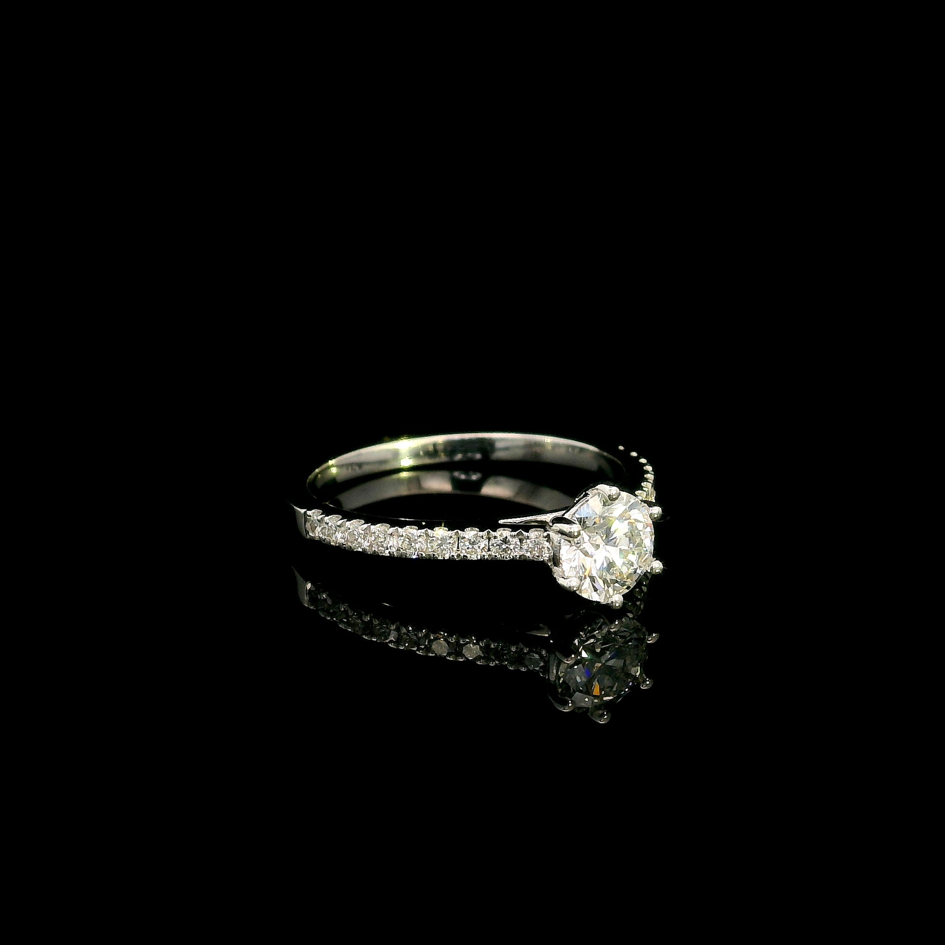 Round diamond bridal set in 18K white gold with GIA certified natural diamond engagement ring and matching diamond wedding band.