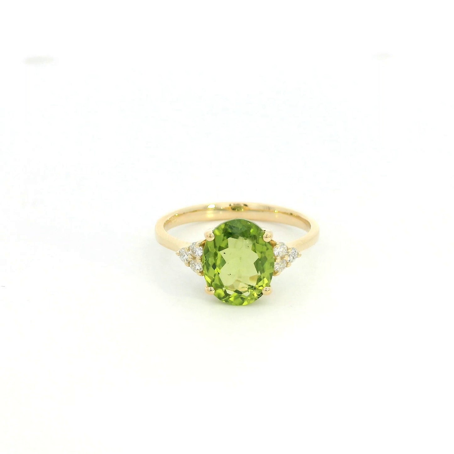 18K yellow gold peridot and diamond ring with oval green centre stone and diamond side accents.