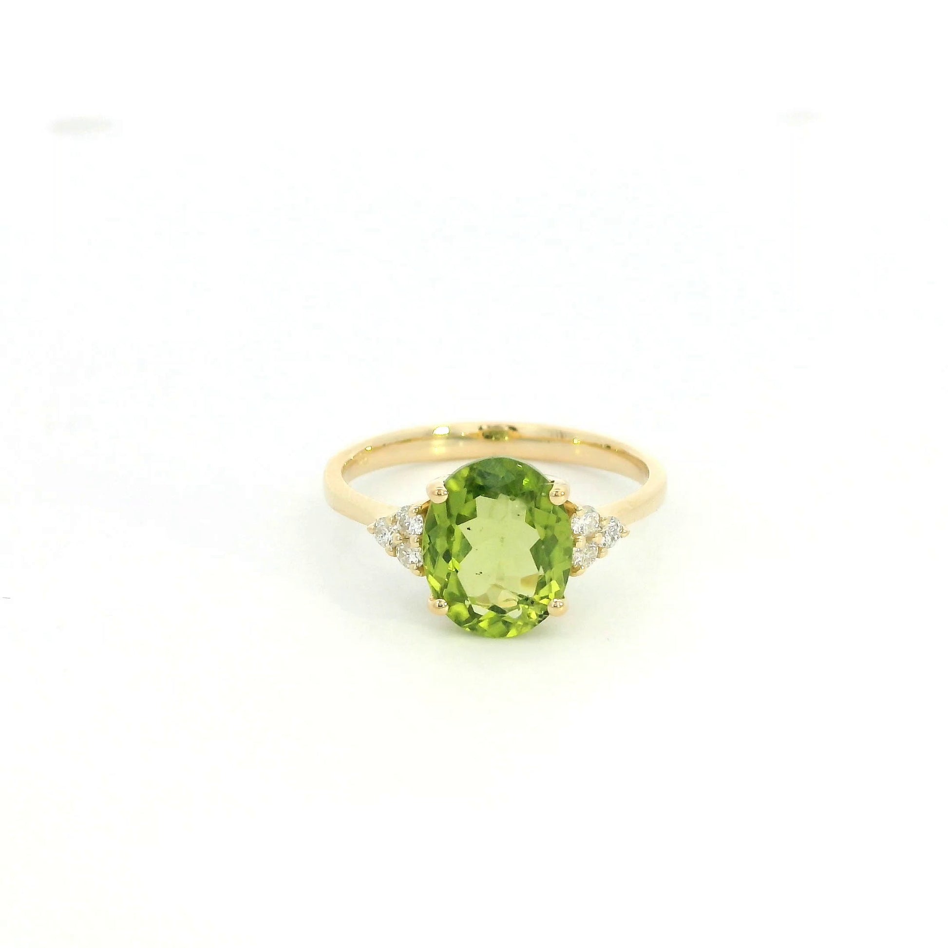 18K yellow gold peridot and diamond ring with oval green centre stone and diamond side accents.