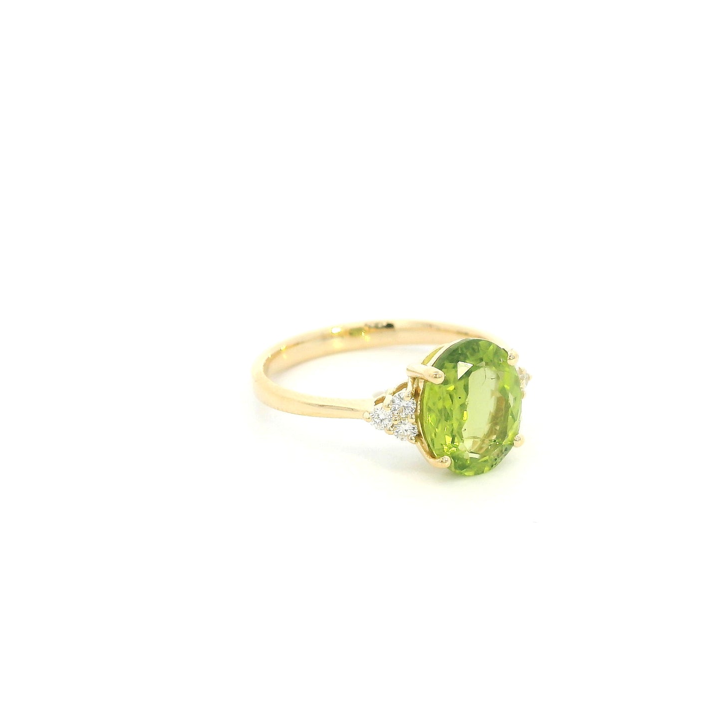 18K yellow gold peridot and diamond ring with oval green centre stone and diamond side accents.