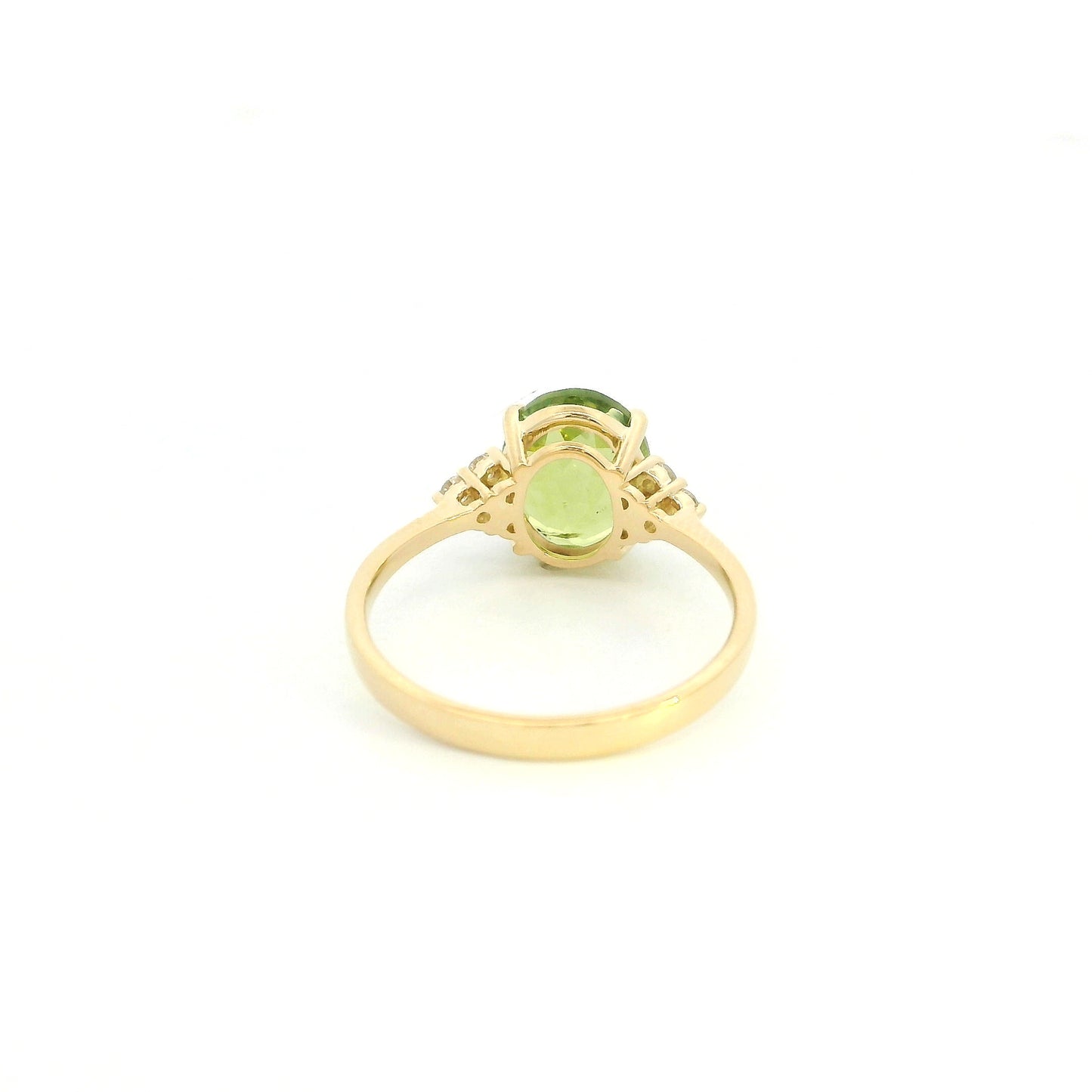 18K yellow gold peridot and diamond ring with oval green centre stone and diamond side accents.