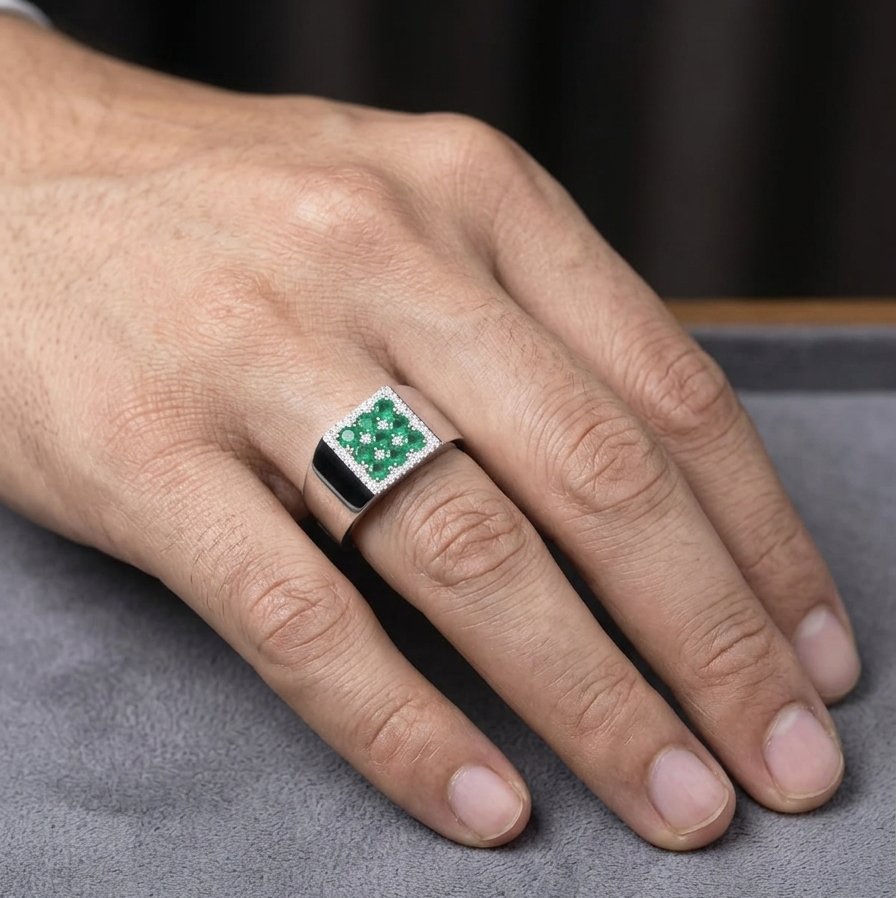 Men’s emerald and diamond signet ring in 18K white gold with nine round emeralds framed by natural diamonds.