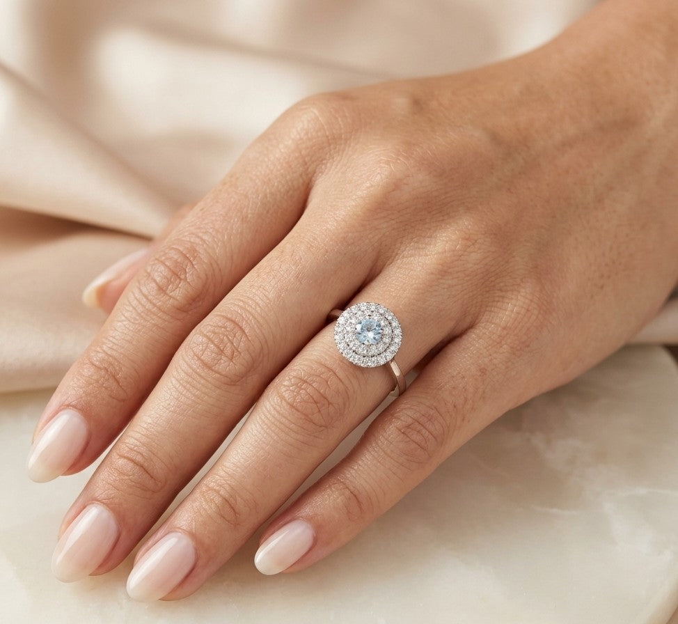 18K white gold aquamarine and diamond double halo ring with round blue aquamarine and two rows of round diamonds