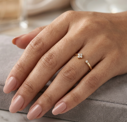 Open diamond flower ring in 18K yellow gold with four-petal diamond floral design and single diamond accent