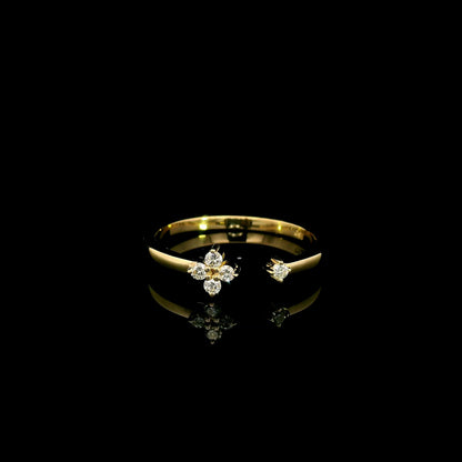 Open diamond flower ring in 18K yellow gold with four-petal diamond floral design and single diamond accent