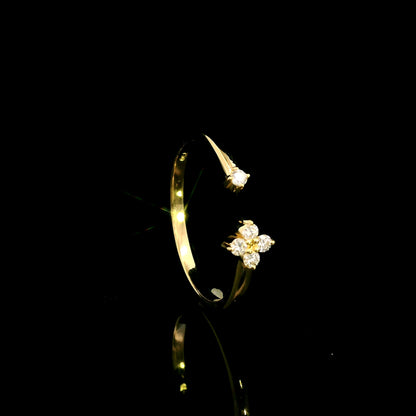 Open diamond flower ring in 18K yellow gold with four-petal diamond floral design and single diamond accent