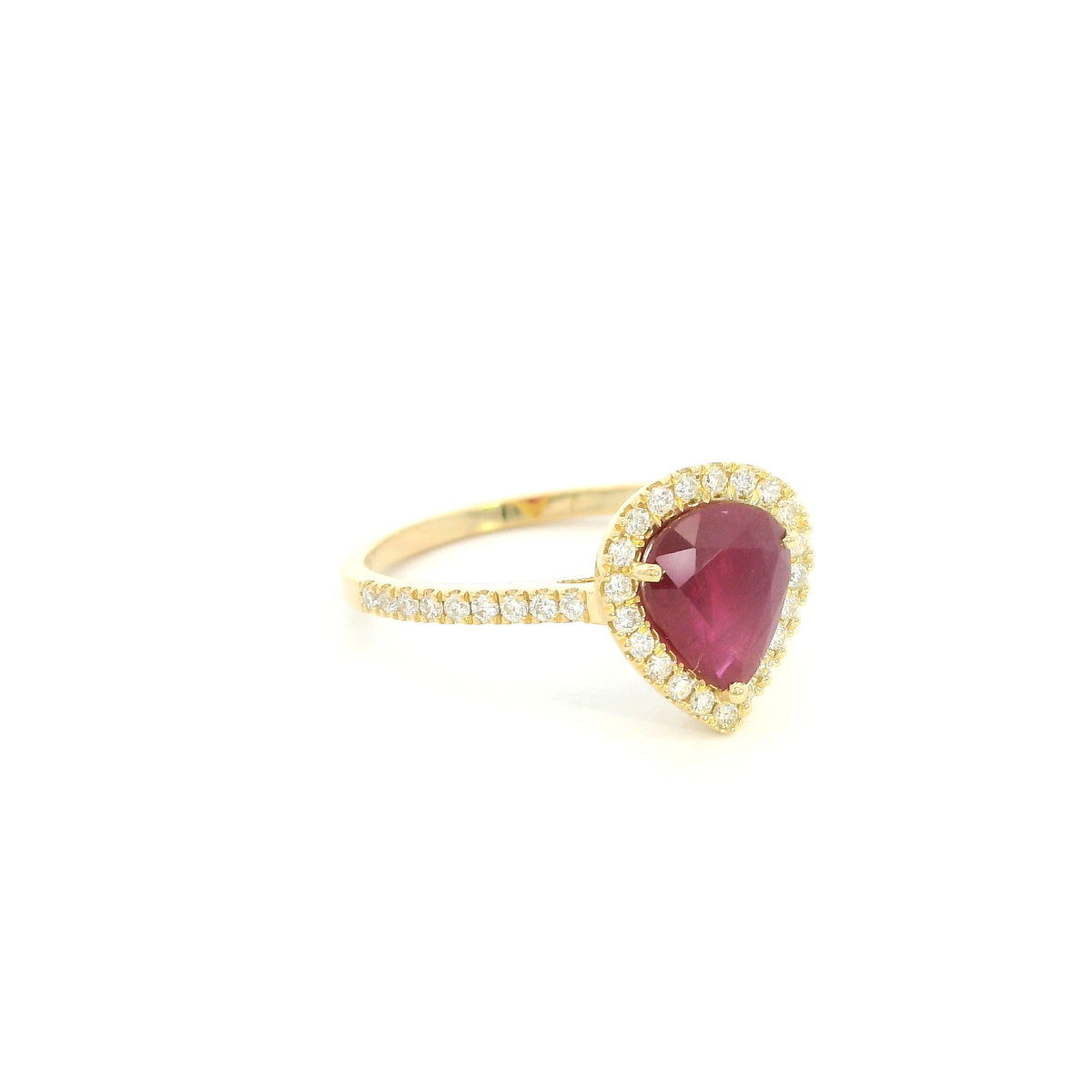 Pear shaped ruby and diamond halo ring in 18K yellow gold with diamond-set shoulders