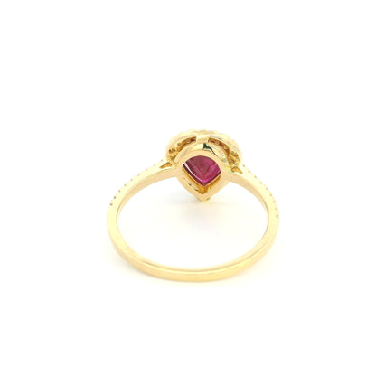 Pear shaped ruby and diamond halo ring in 18K yellow gold with diamond-set shoulders