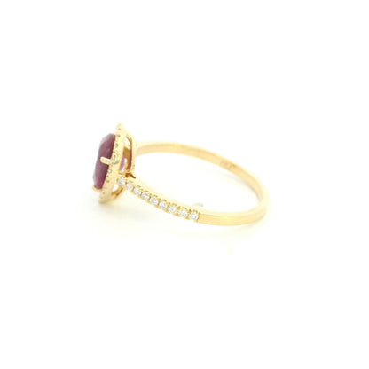 Pear shaped ruby and diamond halo ring in 18K yellow gold with diamond-set shoulders