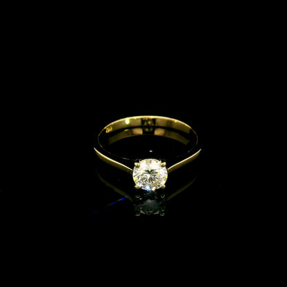 Round diamond solitaire engagement ring in 18K yellow gold with four-prong setting and tapered band