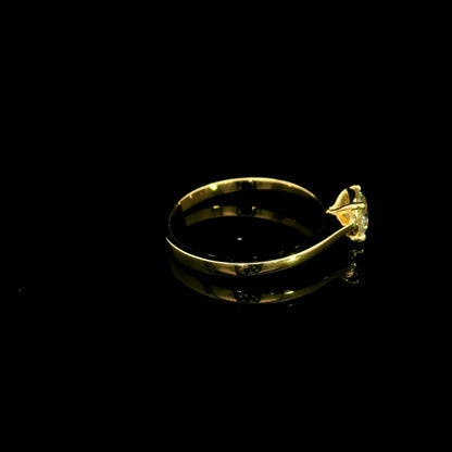 Round diamond solitaire engagement ring in 18K yellow gold with four-prong setting and tapered band