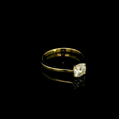 Round diamond solitaire engagement ring in 18K yellow gold with four-prong setting and tapered band