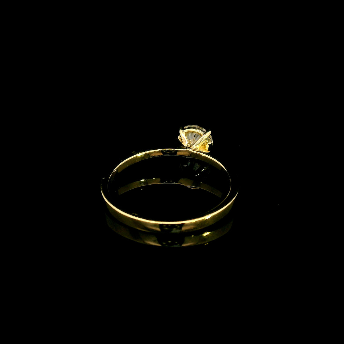 Round diamond solitaire engagement ring in 18K yellow gold with four-prong setting and tapered band