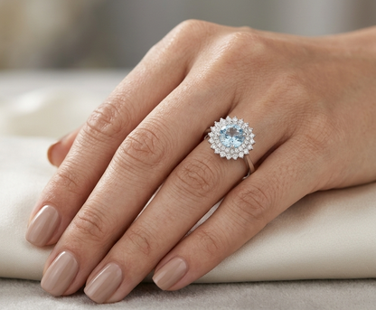 Round aquamarine and diamond double halo ring in 18K white gold with a 1.52 carat natural aquamarine.
