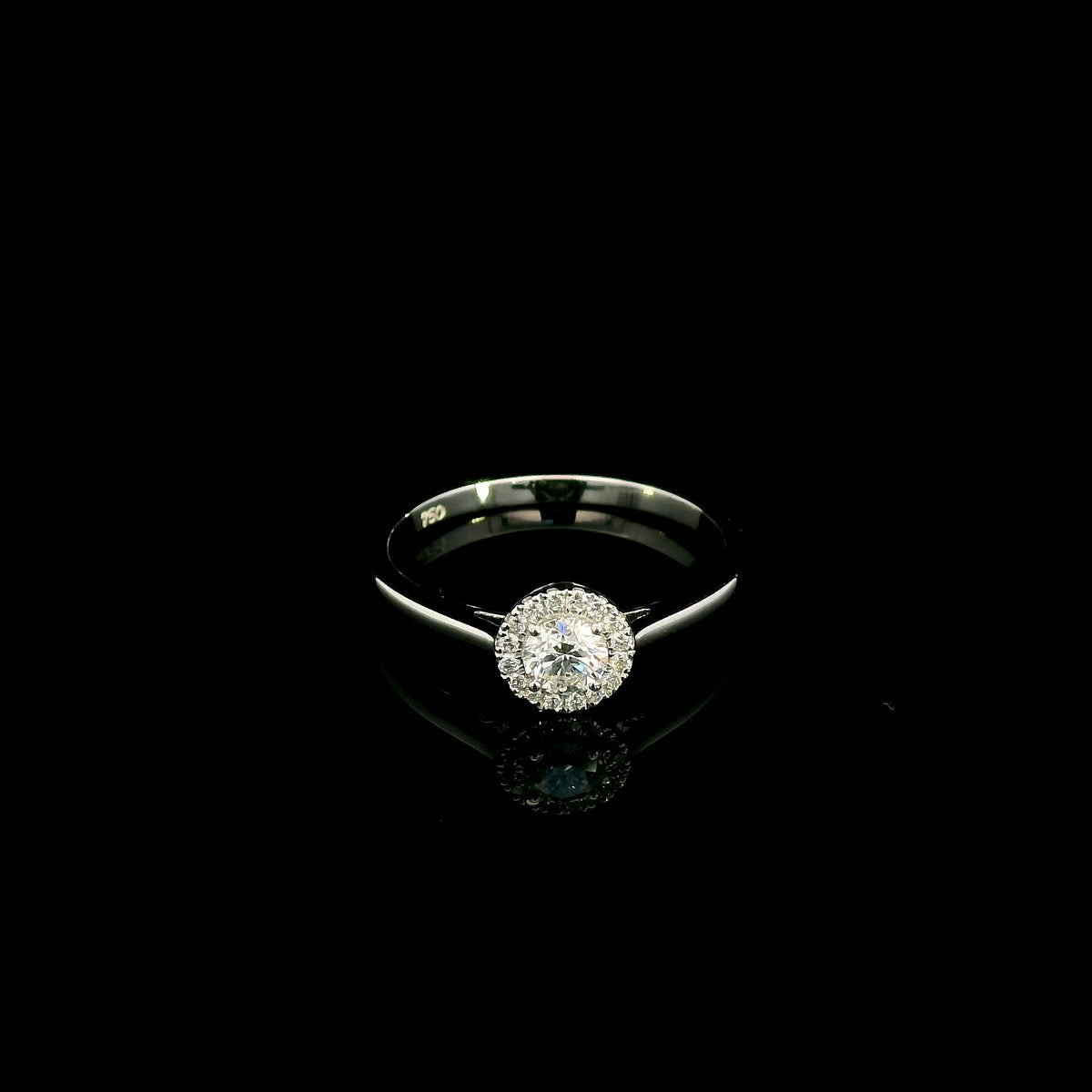 Round diamond halo engagement ring in 18K white gold