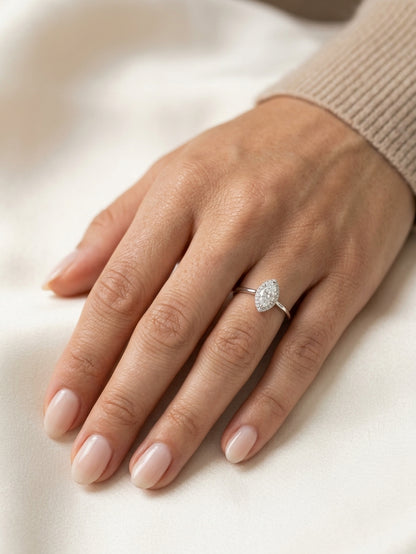 Marquise diamond halo engagement ring in 18K white gold featuring a marquise centre diamond surrounded by a fine round diamond halo.