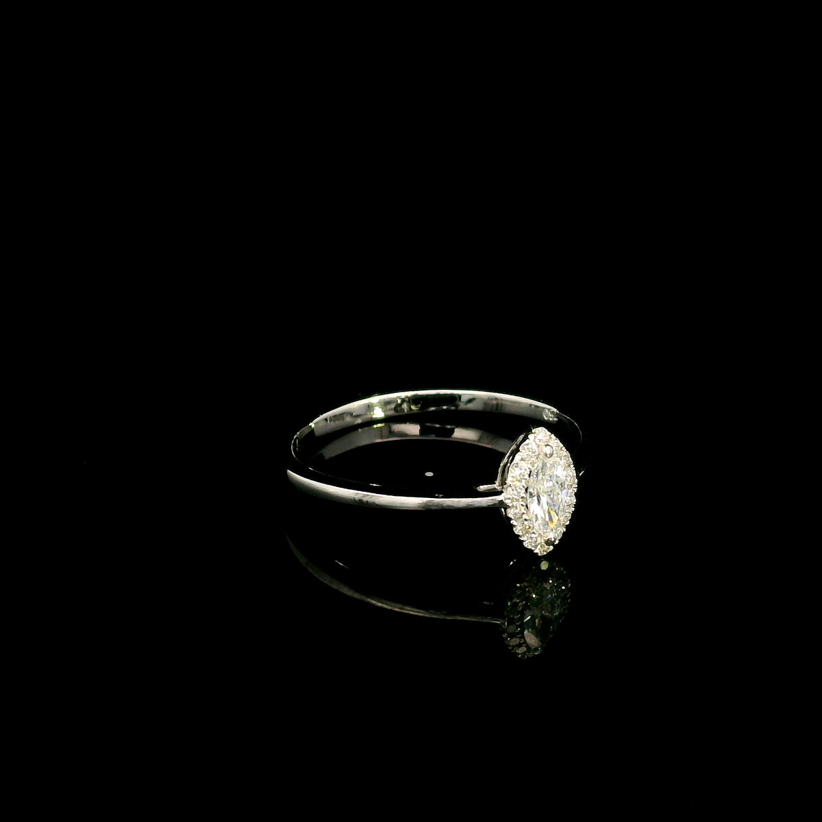 Marquise diamond halo engagement ring in 18K white gold featuring a marquise centre diamond surrounded by a fine round diamond halo.