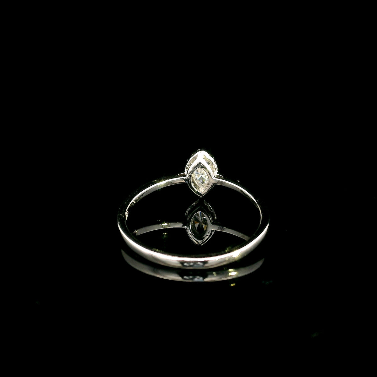 Marquise diamond halo engagement ring in 18K white gold featuring a marquise centre diamond surrounded by a fine round diamond halo.