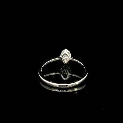 Marquise diamond halo engagement ring in 18K white gold featuring a marquise centre diamond surrounded by a fine round diamond halo.