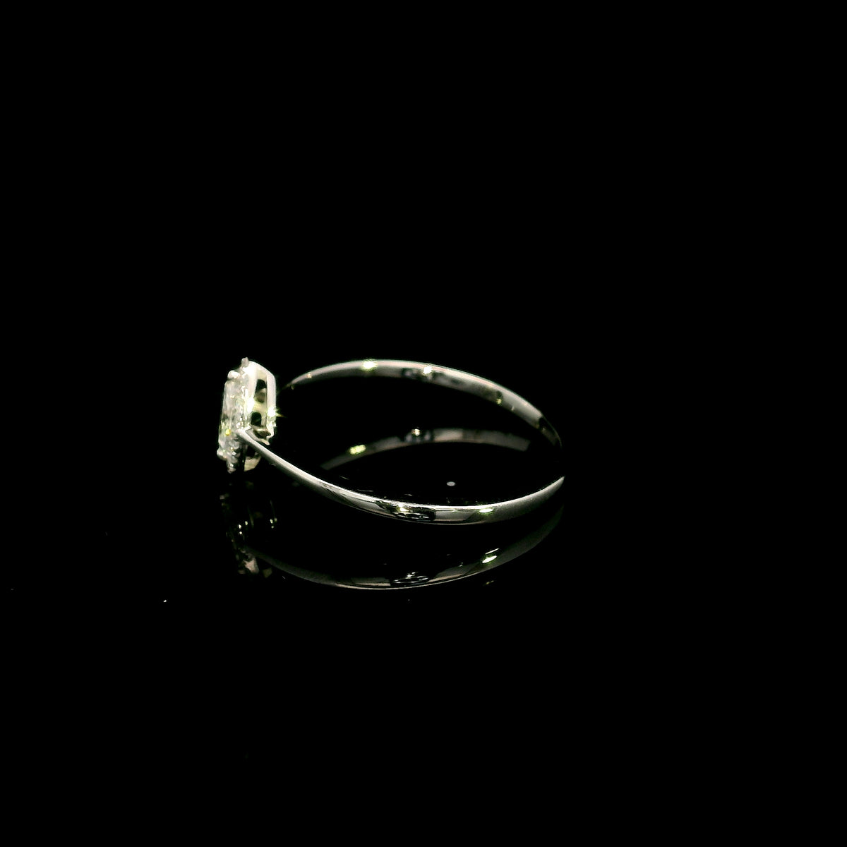 Marquise diamond halo engagement ring in 18K white gold featuring a marquise centre diamond surrounded by a fine round diamond halo.
