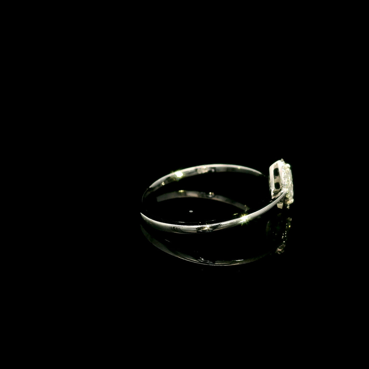 Marquise diamond halo engagement ring in 18K white gold featuring a marquise centre diamond surrounded by a fine round diamond halo.