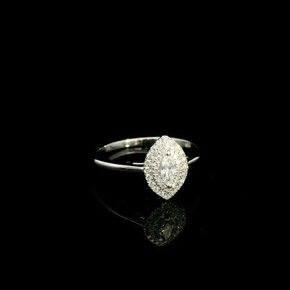Marquise diamond halo engagement ring in 18K white gold with a marquise centre diamond surrounded by a sparkling diamond halo.